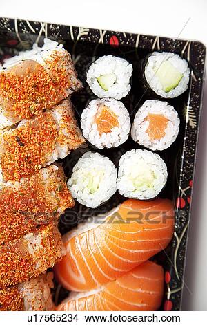 Picture - Close-up of sushi food on tray against white background. Fotosearch