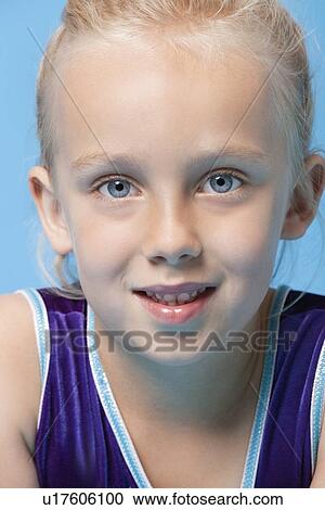 Close-up portrait of a young female gymnast over blue background View Large Photo Image Stock Image - Close-up portrait of a young female gymnast over blue background. Fotosearch