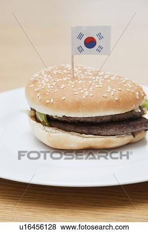 Fresh hamburger in plate with South Korean flag on wooden surface View Large Photo Image Stock Photo - Fresh hamburger in plate with South Korean flag on wooden surface. Fotosearch