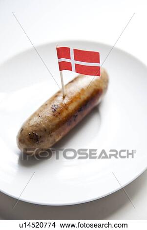 Picture - Fried sausage in plate with Danish flag decoration against white background. Fotosearch
