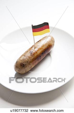 Fried sausage in plate with German flag decoration against white background View Large Photo Image Stock Image - Fried sausage in plate with German flag decoration against white background. Fotosearch