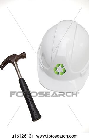 Stock Image - Hammer and hard with recycling symbol against white background. Fotosearch