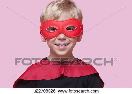 Portrait of a happy boy in superhero costume over pink background View Large Photo Image Stock Photograph - Portrait of a happy boy in superhero costume over pink background. Fotosearch