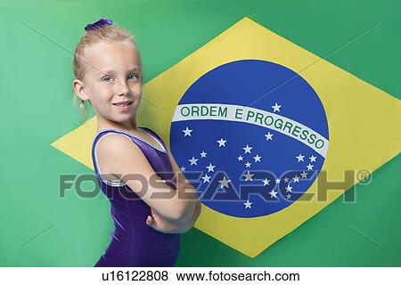Portrait of a happy young female gymnast with arms crossed standing in front of South American flag View Large Photo Image Stock Photo - Portrait of a happy young female gymnast with arms crossed standing in front of South American flag. Fotosearch
