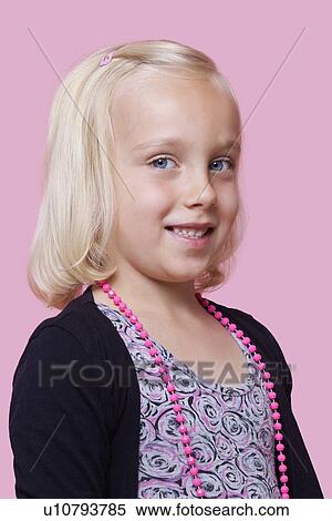 Stock Photography - Portrait of a happy young girl over pink background. Fotosearch