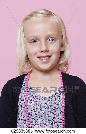 Stock Photography - Portrait of a happy young girl over pink background. Fotosearch