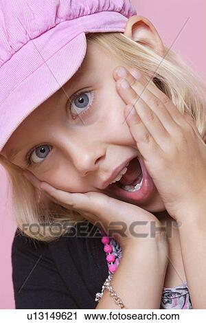 Portrait of a surprise young girl with hands on face over pink background View Large Photo Image Stock Image - Portrait of a surprise young girl with hands on face over pink background. Fotosearch