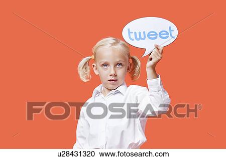 Portrait of a young girl holding tweet bubble against orange background View Large Photo Image Stock Image - Portrait of a young girl holding tweet bubble against orange background. Fotosearch