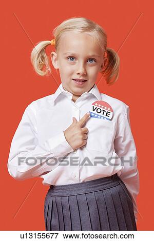 Portrait of a young school girl with vote badge over orange background View Large Photo Image Stock Photo - Portrait of a young school girl with vote badge over orange background. Fotosearch