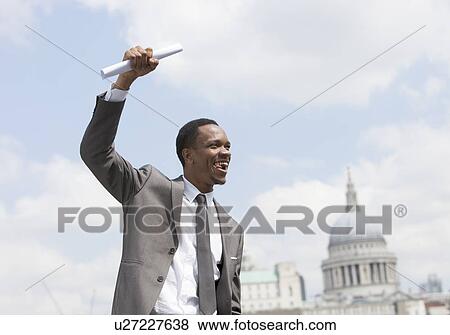 Stock Photo - Portrait of Afircan American businessman celebrating. Fotosearch