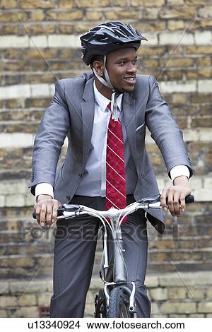Portrait of African American businessman riding Bicycle View Large Photo Image Picture - Portrait of African American businessman riding Bicycle. Fotosearch