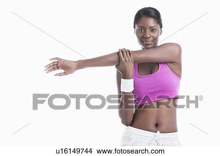 Portrait of an African American young woman stretching arm over white background View Large Photo Image Picture - Portrait of an African American young woman stretching arm over white background. Fotosearch