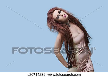 Stock Photo - Portrait of funky young woman posing over blue background. Fotosearch