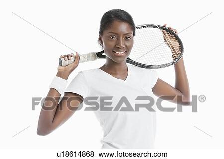 Portrait of young African American woman holding racket over white background View Large Photo Image Stock Photo - Portrait of young African American woman holding racket over white background. Fotosearch