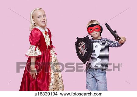 Portrait of young boy and girl in stage costume over pink background View Large Photo Image Picture - Portrait of young boy and girl in stage costume over pink background. Fotosearch