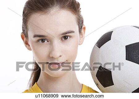 Portrait of young woman with soccer ball against white background View Large Photo Image Stock Photo - Portrait of young woman with soccer ball against white background. Fotosearch