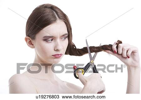 Sad young woman with scissors cutting her hair over white background View Large Photo Image Stock Image - Sad young woman with scissors cutting her hair over white background. Fotosearch