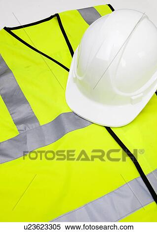 Stock Photography - Safety vest and hard hat against white background. Fotosearch