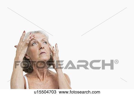 Senior woman suffering from headache against white background View Large Photo Image Stock Image - Senior woman suffering from headache against white background. Fotosearch