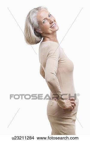 Side view of senior woman in casuals with hands on hips against white background View Large Photo Image Picture - Side view of senior woman in casuals with hands on hips against white background. Fotosearch