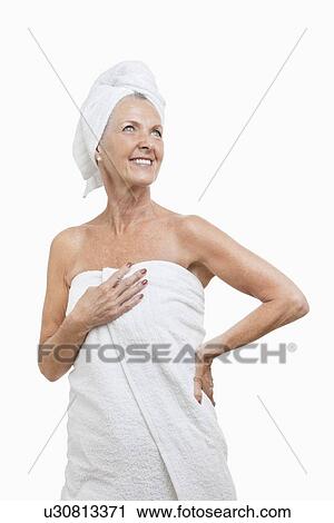Smiling senior woman wrapped in towels against white background View Large Photo Image Stock Image - Smiling senior woman wrapped in towels against white background. Fotosearch