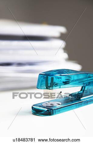 Stapler on white table with stack of papers in background View Large Photo Image Stock Image - Stapler on white table with stack of papers in background. Fotosearch
