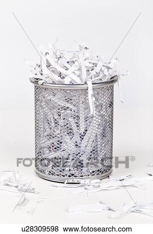 Wastepaper basket with papers lying around over white background View Large Photo Image Stock Photo - Wastepaper basket with papers lying around over white background. Fotosearch