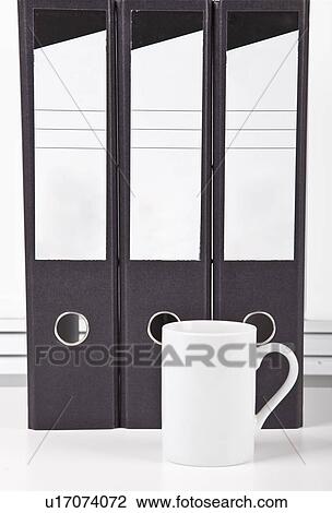 White coffee mug in front of folders at desk View Large Photo Image Stock Image - White coffee mug in front of folders at desk. Fotosearch