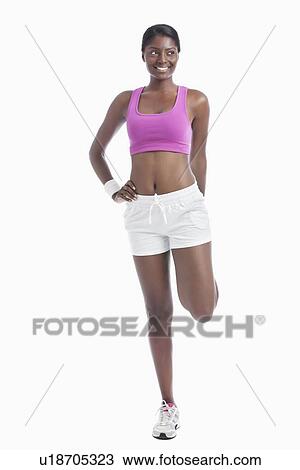 Stock Image - Young African American woman exercising over white background. Fotosearch