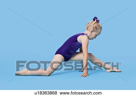 Young girl in bodysuit stretching legs over blue background View Large Photo Image Stock Photo - Young girl in bodysuit stretching legs over blue background. Fotosearch