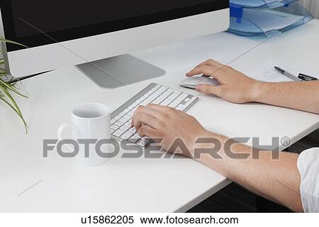 Businessman's hands using computer at desk View Large Photo Image Stock Photography - Businessman's hands using computer at desk. Fotosearch