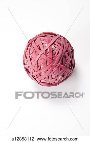 Stock Image - Close-up of rubber band ball over white background. Fotosearch