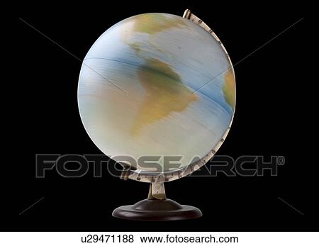 Stock Photo - Close-up of spinning globe over black background. Fotosearch
