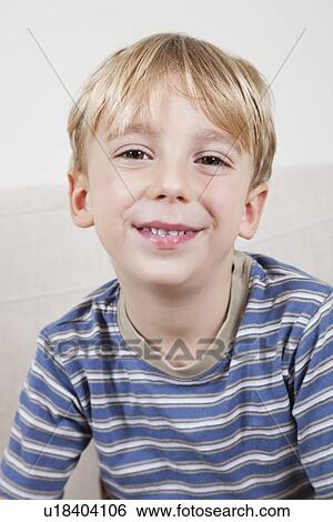Stock Photograph - Close-up portrait of cute young boy smiling. Fotosearch