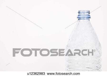 Stock Image - Close-up view of empty plastic bottle over white background. Fotosearch