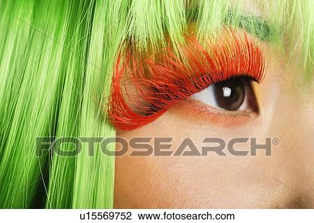 Extreme close-up of young woman's face with false eyelashes and green wig View Large Photo Image Stock Image - Extreme close-up of young woman's face with false eyelashes and green wig. Fotosearch
