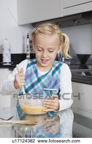 Girl making cookies in mixing bowl at kitchen View Large Photo Image Stock Image - Girl making cookies in mixing bowl at kitchen. Fotosearch