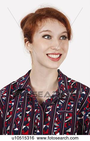 Happy young woman in shirt against gray background View Large Photo Image Stock Photograph - Happy young woman in shirt against gray background. Fotosearch