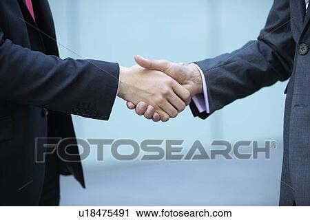 Mid section of business people shaking hands View Large Photo Image Stock Image - Mid section of business people shaking hands. Fotosearch
