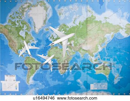Stock Photograph - Model airplanes flying in different direction over world map. Fotosearch