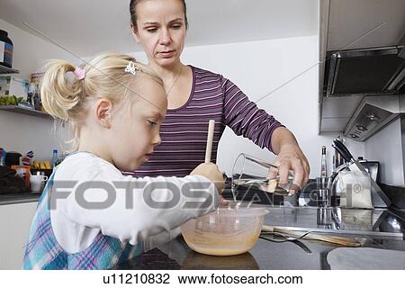 Mother and daughter cooking in kitchen View Large Photo Image Stock Image - Mother and daughter cooking in kitchen. Fotosearch