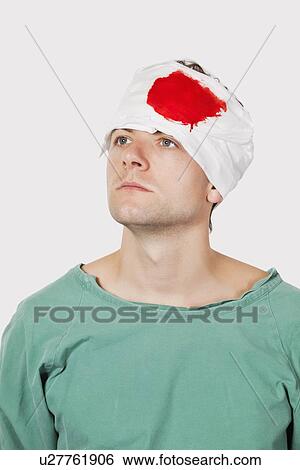 pensive young male patient with serious head injury against gray background View Large Photo Image Stock Photograph - pensive young male patient with serious head injury against gray background. Fotosearch