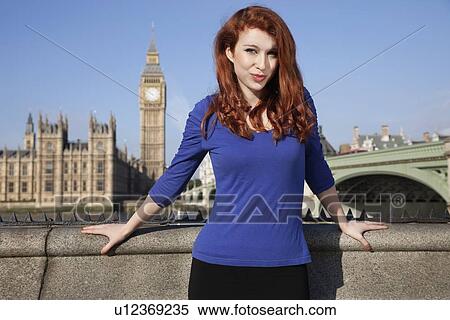 Portrait of beautiful young woman standing against Big Ben clock tower, London, UK View Large Photo Image Stock Photography - Portrait of beautiful young woman standing against Big Ben clock tower, London, UK. Fotosearch