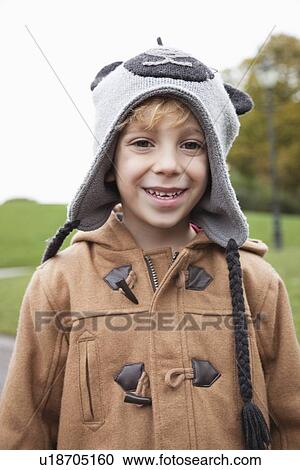 Portrait of cute boy in winter clothing at park View Large Photo Image Stock Image - Portrait of cute boy in winter clothing at park. Fotosearch