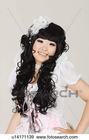 Portrait of cute happy young woman in doll costume posing over gray background View Large Photo Image Stock Photo - Portrait of cute happy young woman in doll costume posing over gray background. Fotosearch