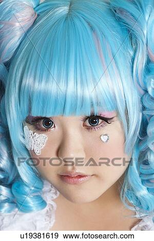 Portrait of cute woman wearing blue wig over gray background View Large Photo Image Stock Photo - Portrait of cute woman wearing blue wig over gray background. Fotosearch