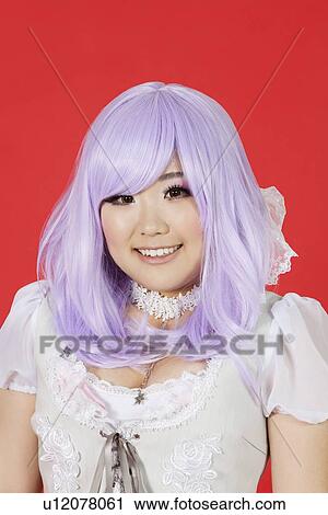 Portrait of cute young woman in doll costume and purple wig over red background View Large Photo Image Stock Image - Portrait of cute young woman in doll costume and purple wig over red background. Fotosearch