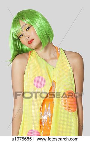 Portrait of funky young woman with green hair standing against gray background View Large Photo Image Stock Image - Portrait of funky young woman with green hair standing against gray background. Fotosearch