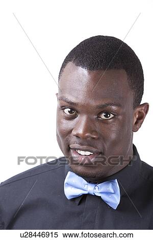 Portrait of happy young African American man in bow tie against white background View Large Photo Image Stock Photography - Portrait of happy young African American man in bow tie against white background. Fotosearch