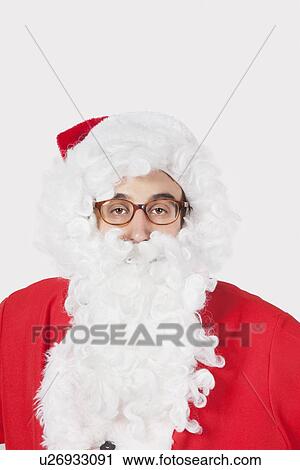 Portrait of man in Santa costume against gray background View Large Photo Image Stock Image - Portrait of man in Santa costume against gray background. Fotosearch